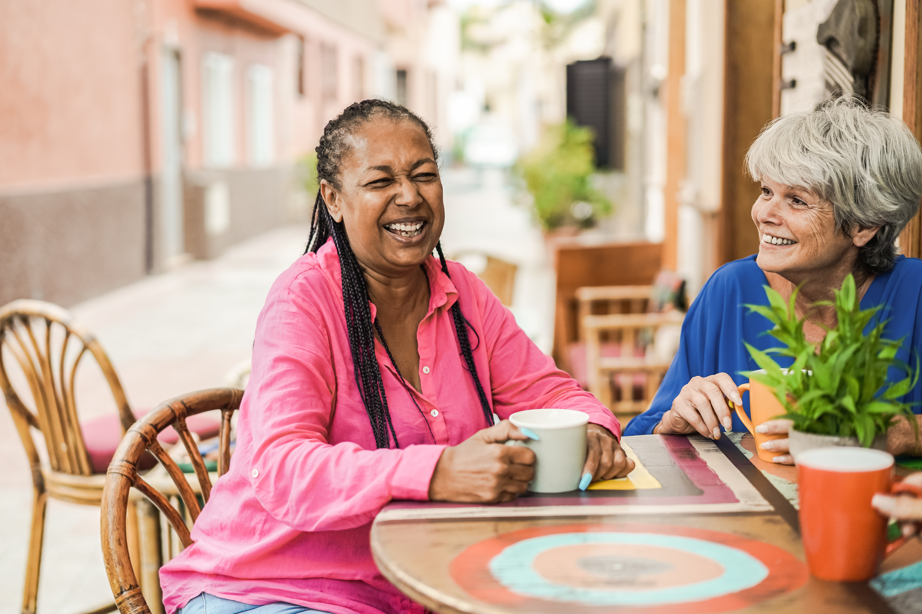 Two women sharing a warm conversation over coffee.